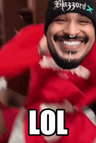 a man with a beard wearing a beanie that says blazord on it