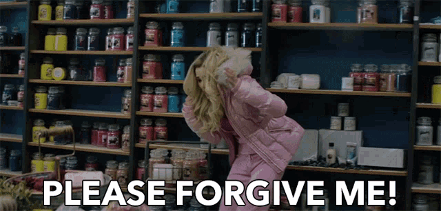a woman in a pink jacket stands in front of a shelf full of candles and says " please forgive me "