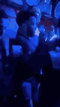 a blurry photo of people dancing in a club