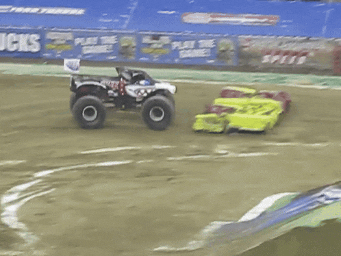 a monster jam speed race is taking place in front of a large crowd