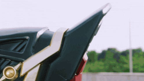 a close up of a car 's tail light with a green background