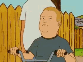 a cartoon character from king of the hill is riding a bike .