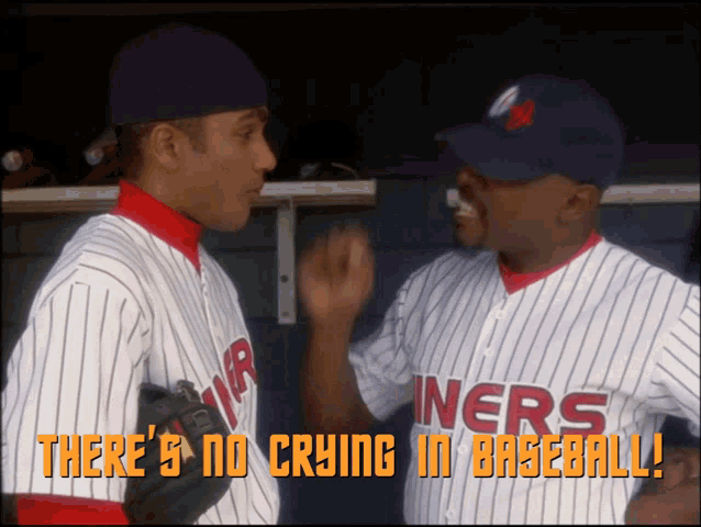 two baseball players talking in a dugout with the words " there 's no crying in baseball " above them