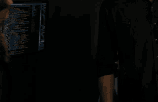 a man in a black shirt is standing next to a woman