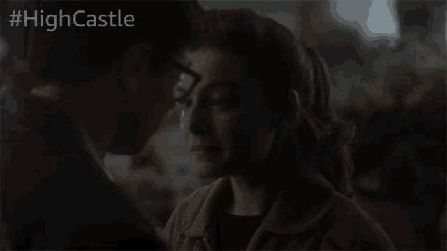 a man and a woman kissing in a dark room with the hashtag #highcastle