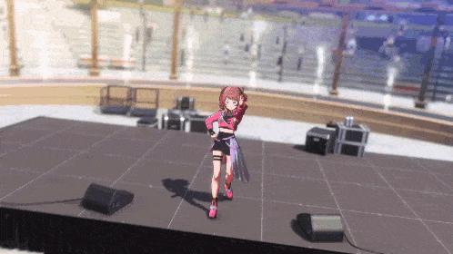 a girl is standing on a stage in front of a speaker