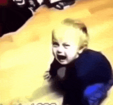 a baby is crawling on the floor and crying .