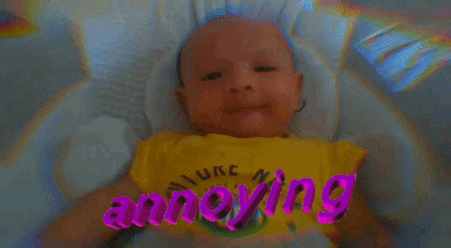a baby wearing a yellow shirt that says annoying on it