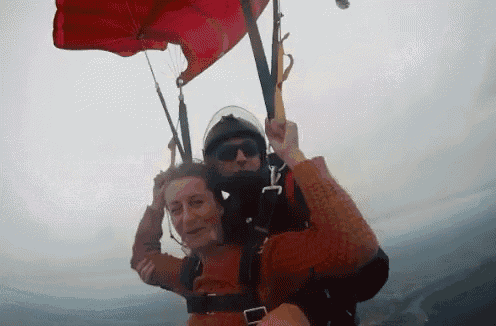 a man and a woman are flying through the air