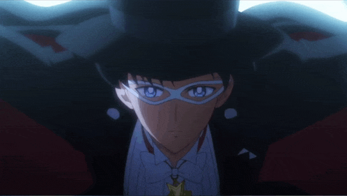 a man wearing a mask and a top hat looks at the camera