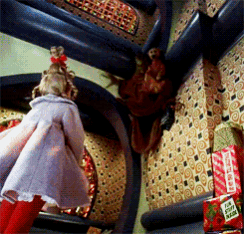 a doll is standing in a room next to a box that says ' i love santa claus ' on it