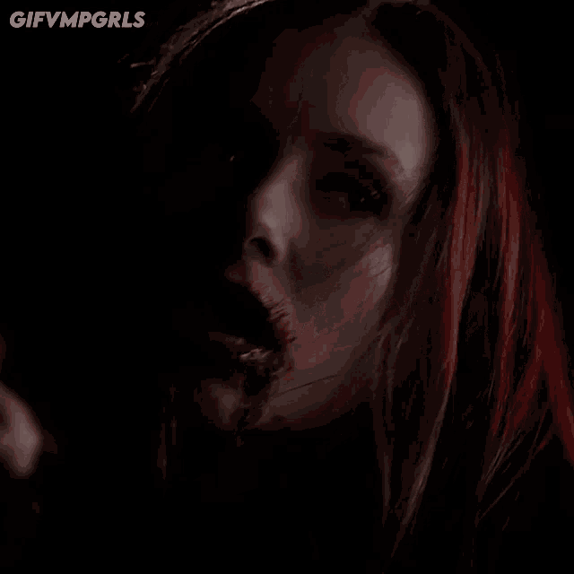 a close up of a woman 's face with blood coming out of her mouth and the words gifvmpgirls below her
