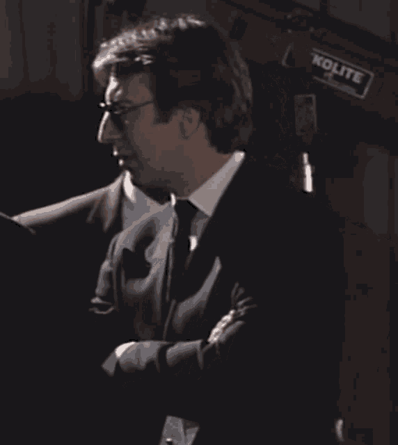 a man in a suit and tie with sunglasses on