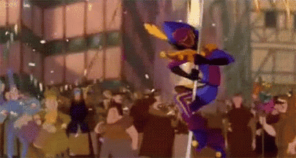 a cartoon character is standing on a pole in a crowd of people .