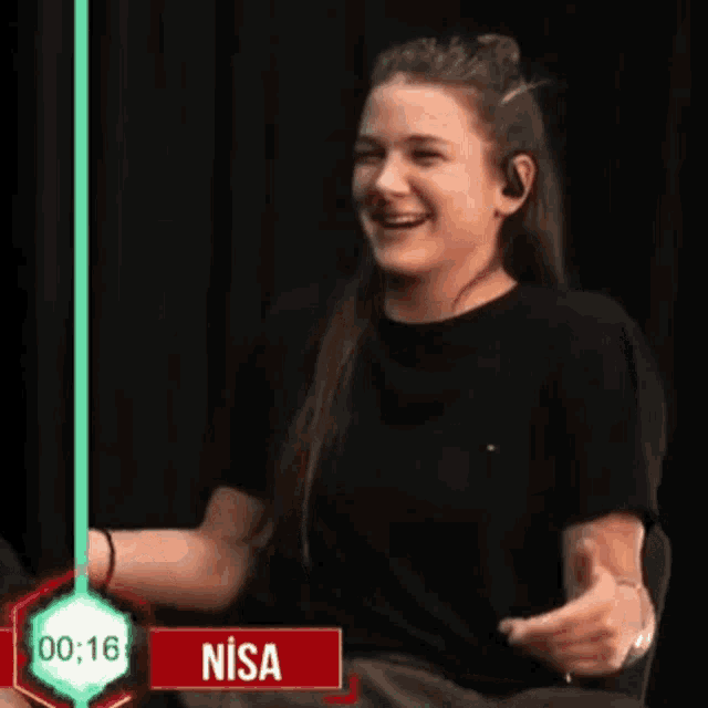 a woman is laughing in front of a timer that says nisa on it