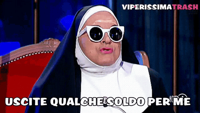 a nun wearing sunglasses is sitting in a chair and says " uscite qualche "