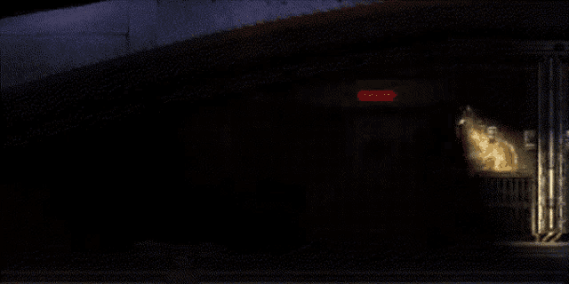 a dark room with a red light on the right
