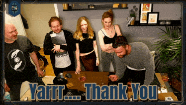 a group of people standing around a table with the words yarrr thank you in the corner