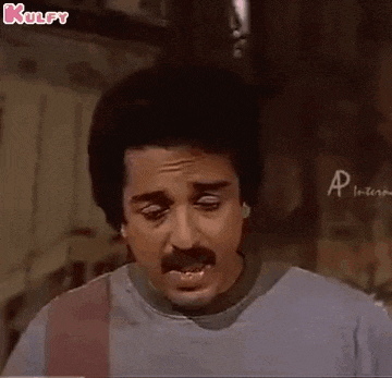 a man with a mustache is making a funny face in a room .