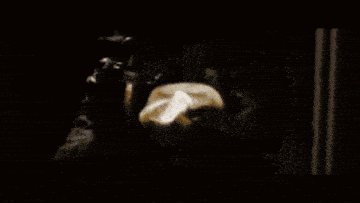 a black and white photo of a person 's face in a dark room