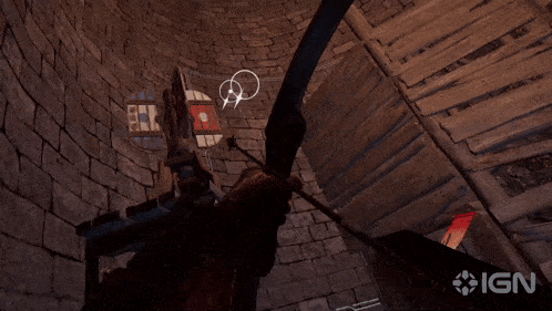 a person holding a bow and arrow in front of a sign that says ign on it