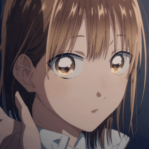 a close up of a girl 's face with brown hair and a white shirt