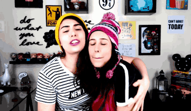 two women are hugging each other in front of a wall with a sign that says " can 't adult today "