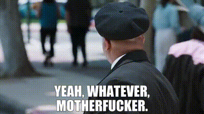 a man in a suit and beret is standing on a sidewalk and says `` yeah , whatever , motherfucker ''