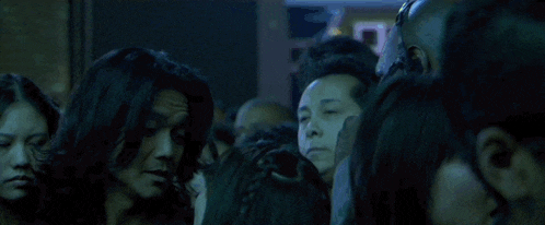 a close up of a man 's face in a crowd