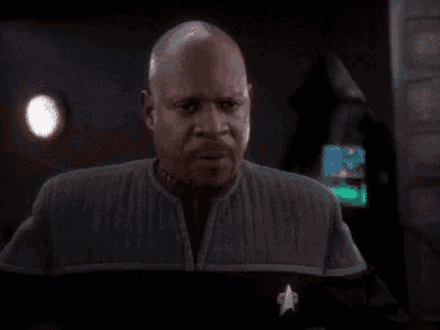 a bald man is pointing at the camera and saying " i will fucking beam you into the wormhole "
