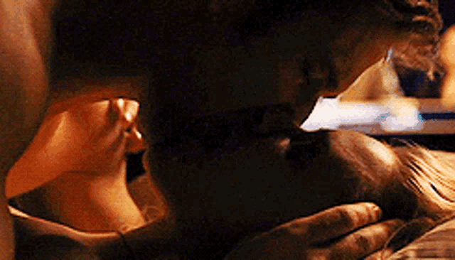 a close up of a man and woman kissing