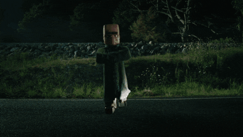 a car is driving down a road at night and a person is flying in the air