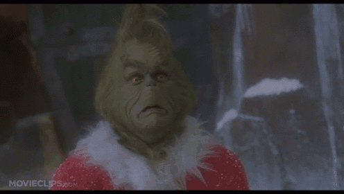a close up of a grinch 's face from movieclips.com