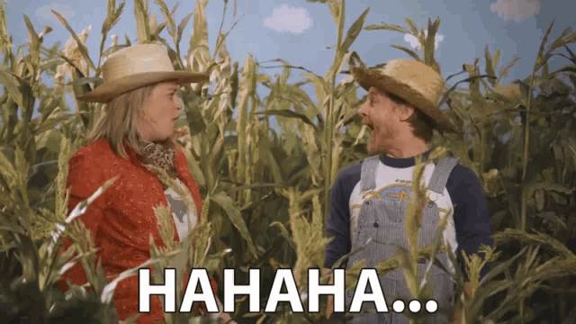 a man and a woman are laughing in a corn field with the words hahaha written on the bottom