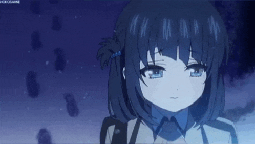 a girl with short black hair and blue eyes is standing in the snow in a dark room .
