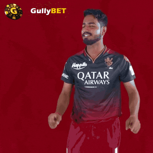 a man wearing a qatar airways shirt holds up his fingers