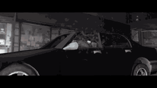 a man is sitting in a car in front of a store