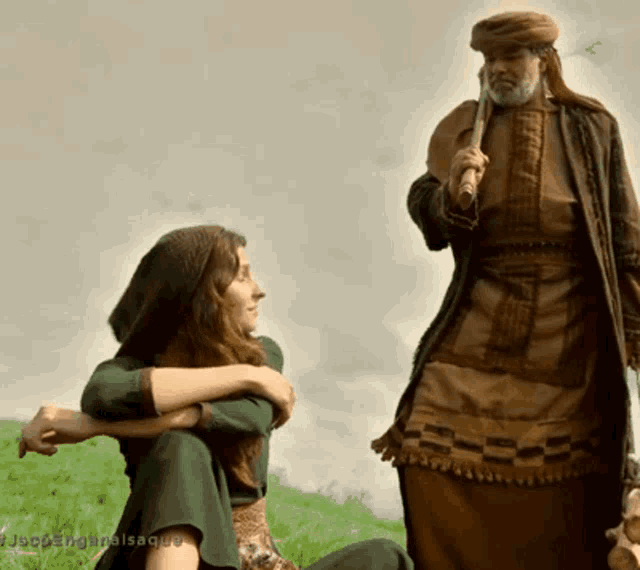a man in a turban stands next to a woman in a green dress and the words jacobangalsaque are visible