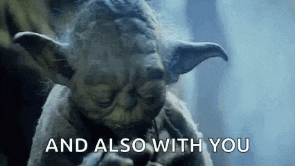 a close up of a statue of yoda with the words `` and also with you '' written on it .