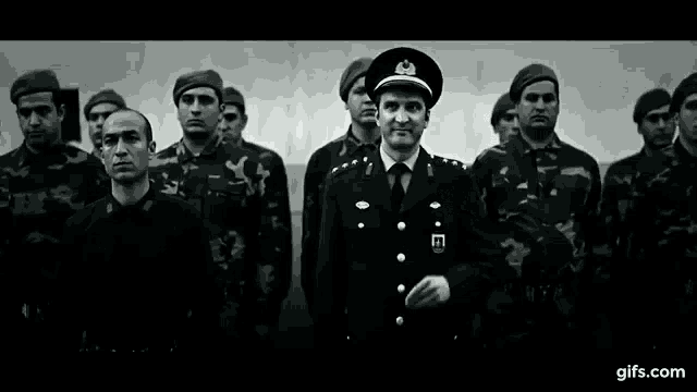 a black and white photo of a group of soldiers standing in a row