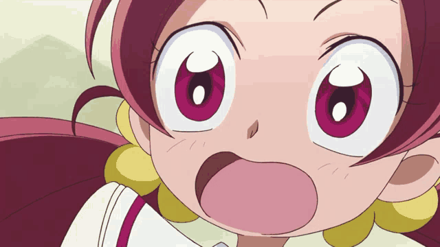 a close up of a girl 's face with big eyes