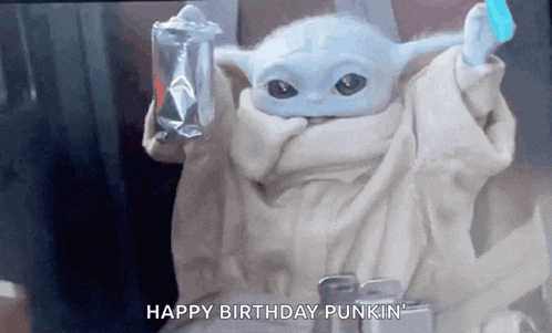a baby yoda from star wars is holding a bag of chips and a blue ice cream stick .