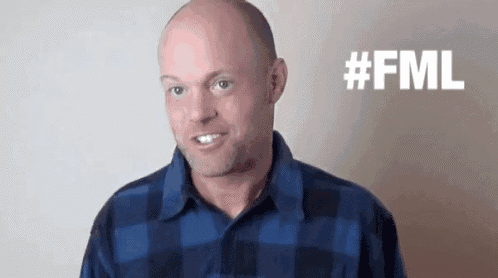 a bald man wearing a blue plaid shirt is smiling with the words #fml behind him .