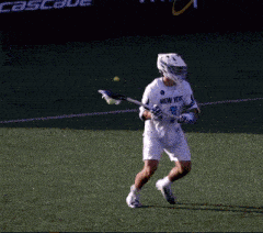 a lacrosse player wearing a white jersey that says wyoy