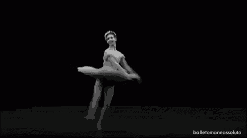 a black and white photo of a ballerina in a tutu jumping in the air on a black background .