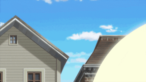 a house with a blue sky and clouds behind it