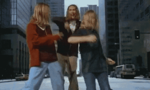 a group of young people are dancing on a city street