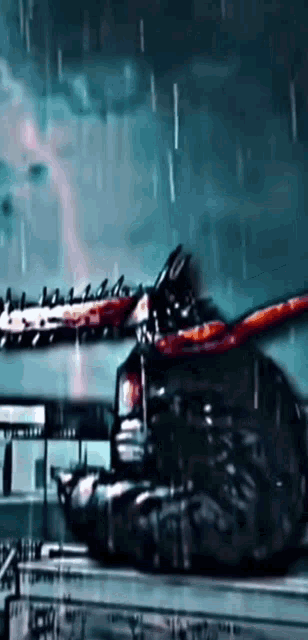 a person is holding a chainsaw in a dark room in the rain .