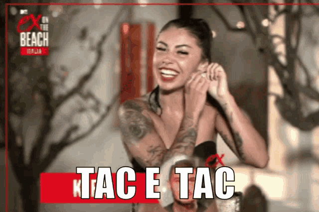 a woman with a tattoo on her arm is laughing with the words tac e tac on the bottom