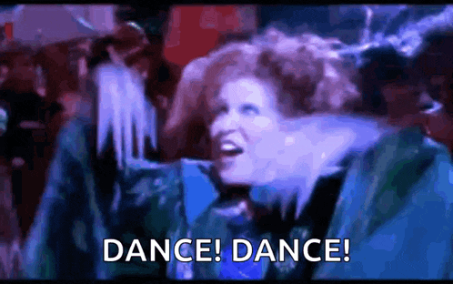 a woman is dancing in a club with the words `` dance ! dance ! '' written on the bottom .